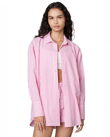 model wearing long sleeve hot pink and white striped button down top and matching shorts