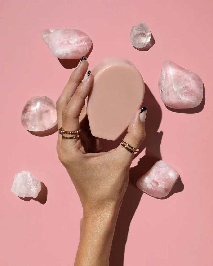 model holding cactus soap with pink quartz surrounding them