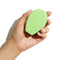 model holding green bar of soap in their hand
