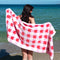 model holding towel with coral, pink and white checked pattern