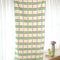 opened cream towel with kelly green and lilac stripes (and the reversible side is green with cream and lilac stripes)