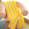 yellow towel with lavender stripes on a pink chair