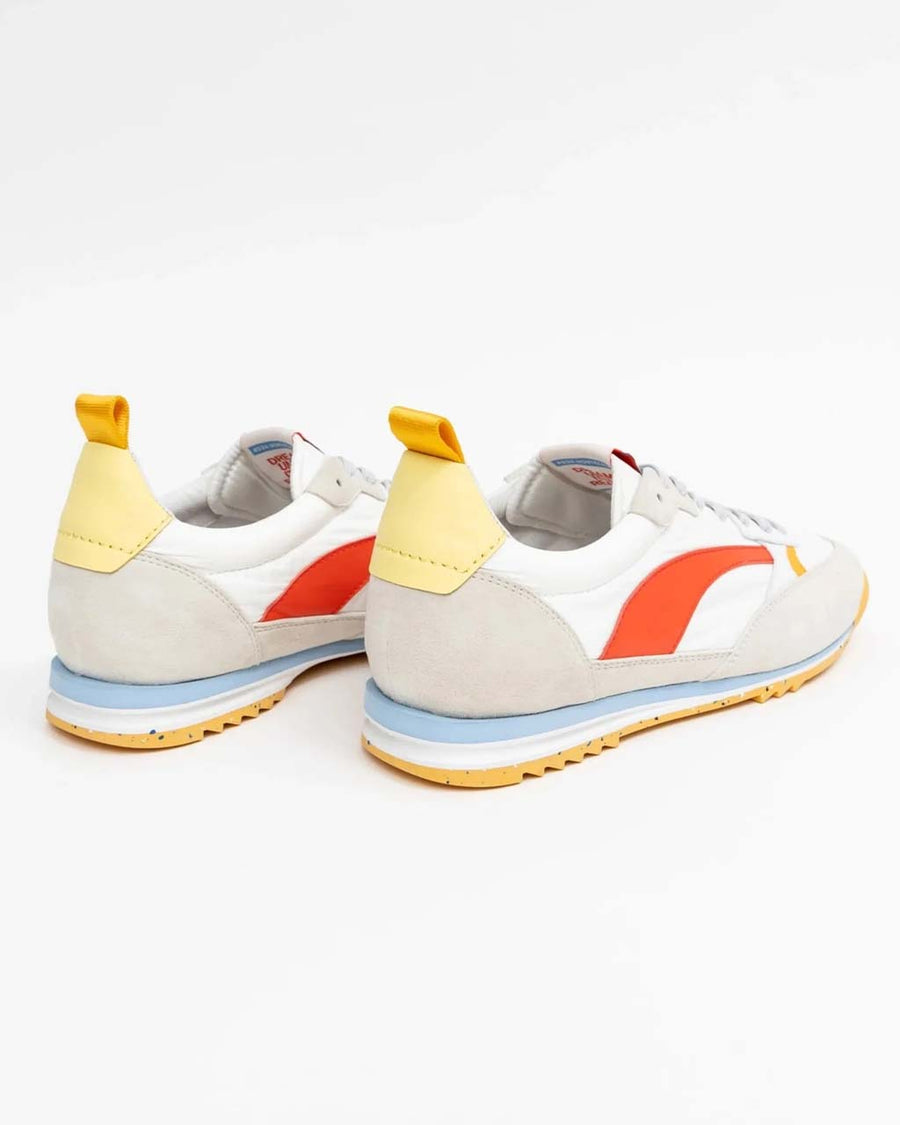back view of white sneakers with orange, yellow and blue retro accents