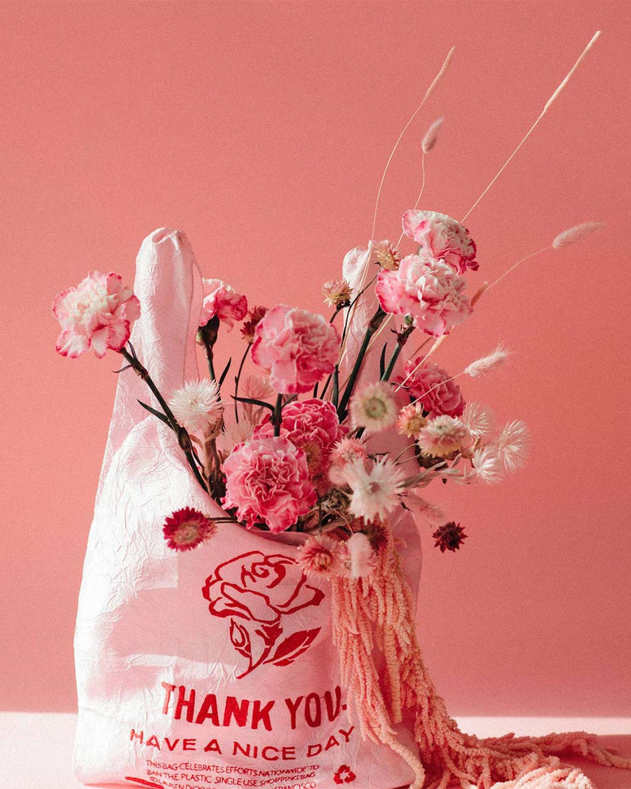 pink reusable bag with red rose thank you embroidery with flowers inside