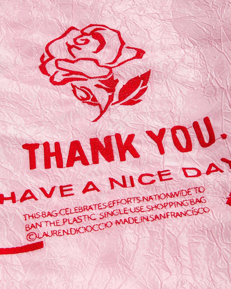 up close of pink reusable bag with red rose thank you embroidery