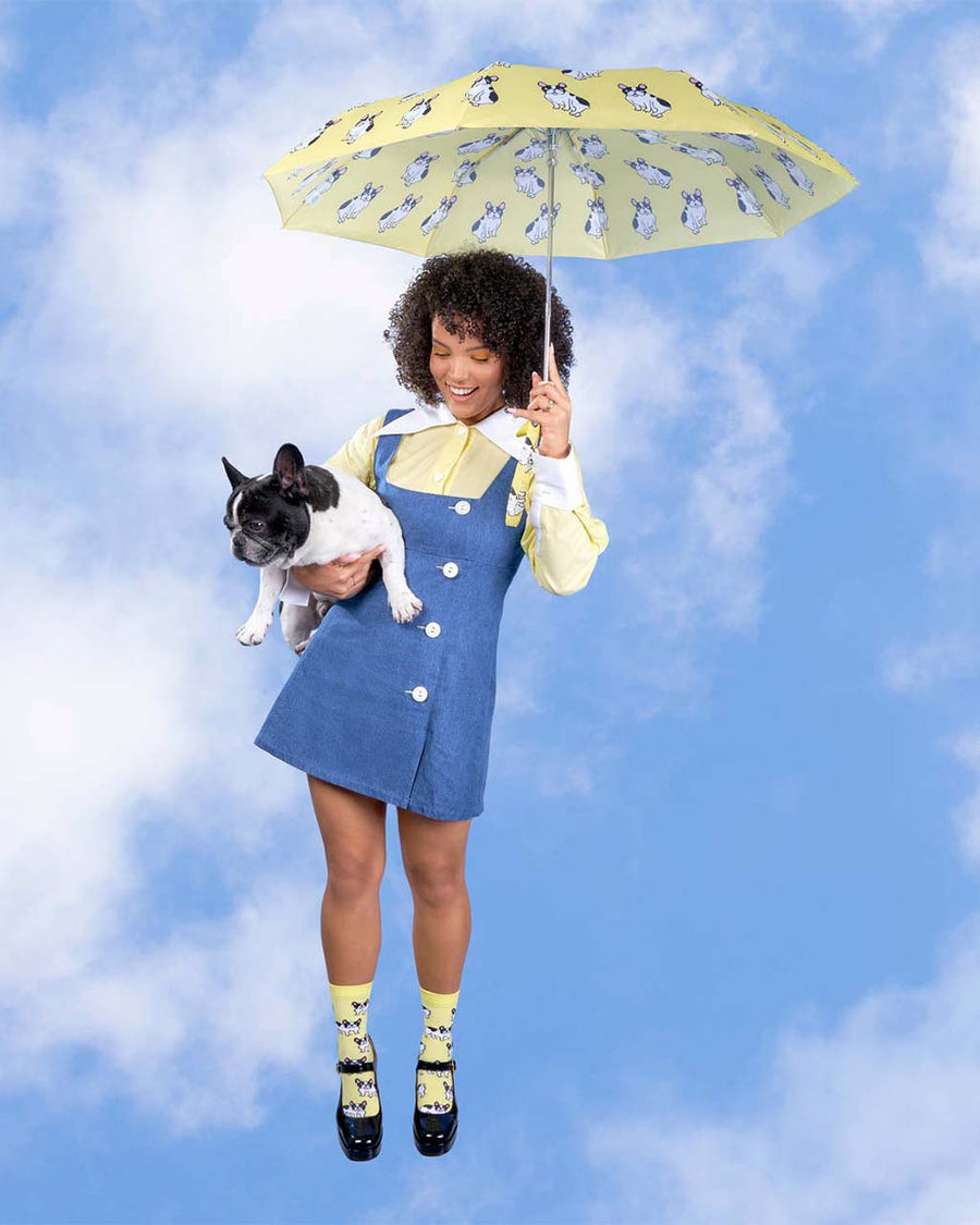 model holding yellow duckhead umbrella with all over french bulldog print
