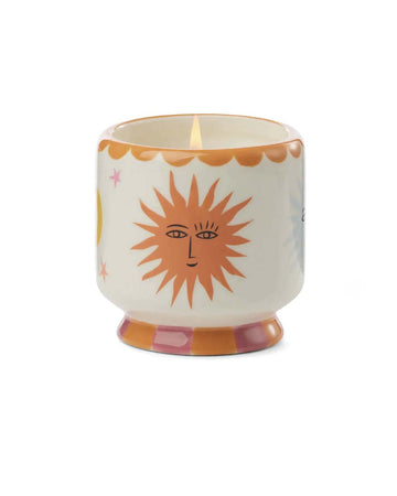 cream 8 oz candle with orange sun and moon print