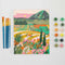 painted mini paint by numbers kit with colorful italian countryside scene with brushes and pots of acrylic paint
