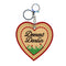 reverse side of keychain with black 'deerest darlin' with a flower field beneath it.