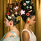green, red and cream ornament shaped hair claw in models hair