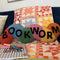 colorful worm throw pillow with 'BOOKWORM' across the front
