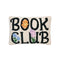cream rectangular throw pillow with black 'BOOK CLUB' across the front and colorful floral print