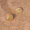 gold seashell huggie earrings in the sand