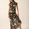 model wearing black fitted mesh top with ruffle sleeves and all over pasta and veggie print and matching skirt