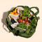 sage green cotton tote bag with various groceries inside the 6 interior pockets