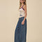 side view of model wearing dark blue denim wide leg pants with drawstring waist, elastic waist and raw hems