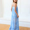 back view of model wearing light blue maxi dress with ruffle hem and white floral print