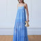 model wearing light blue maxi dress with ruffle hem and white floral print