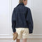 back view of model wearing oversized high neck denim cropped jacket with tie drawstring hem