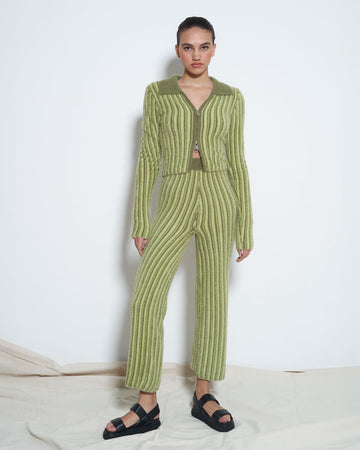 model wearing green tone vertical stripe fuzzy cropped pants with matching zip cardigan