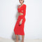 side view of model wearing red fuzzy midi skirt with matching red criss cross top