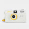 front view of white gudetama 35mm camera without lens cover