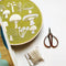 green embroidery kit with cream mushroom design