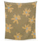 reversible side of brown throw blanket with gold flower print with smiley faces in the center