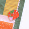 tomato pincushion magnetic needle holder on a piece of fabric