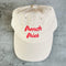 front view of tan dad hat with red 'french fries' across the front