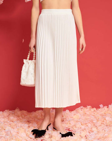 model wearing white pleated midi skirt