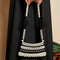 model holding black and white beaded mini handbag