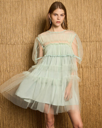 model wearing light green mini dress with pretty sea green tulle tiers