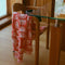 cream and coral red half sun turkish towel with fringe on a chair