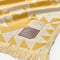 up close of yellow and white geometric driftweave beach blanket