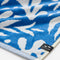 up clsoe of cream and dusty blue abstract palm tree and sun design turkish towel