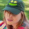 model wearing dark green dad hat with embroidered olive eyes and pickle smile