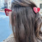 model wearing mini red heart hair claw with paisley print