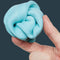 model holding balled up lagoon blue calming putty