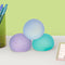 set of three gel stress balls in cool colors: misty blue, teal, and lavender on a desk