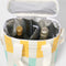bottles of drinks inside of yellow/white and mint/white striped drink cooler