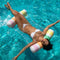 model floating on pastel striped hammock float