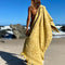 model carrying golden mustard floral textured beach towel