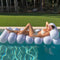 model floating on white luxe tube lilo
