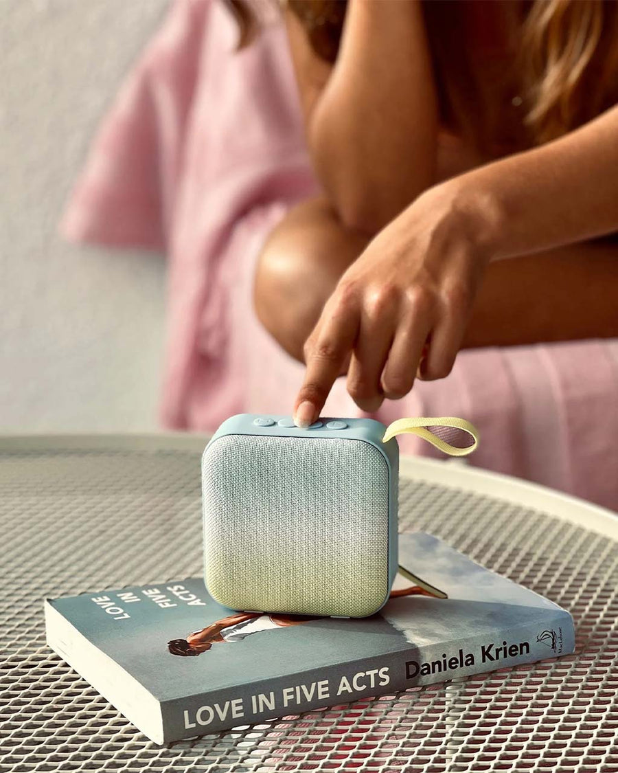 model using square yellow and blue ombre travel speaker