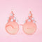 pink pastel sunglasses with pink lens and pink tree with pom details on top