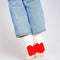 model wearing white socks with red hearts on the heels and jeans