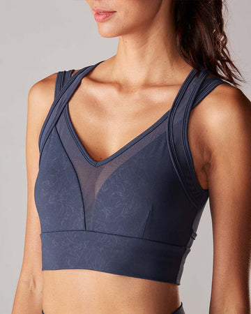 navy sports bra with criss cross detail and pretty lily print