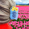 model wearing light blue 'plastic bag' hair claw with 'thank you for being you' across the front and yellow daffodils coming from the top