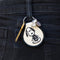 model wearing cream and black patch keychain with skeleton snoopy design on their belt loop